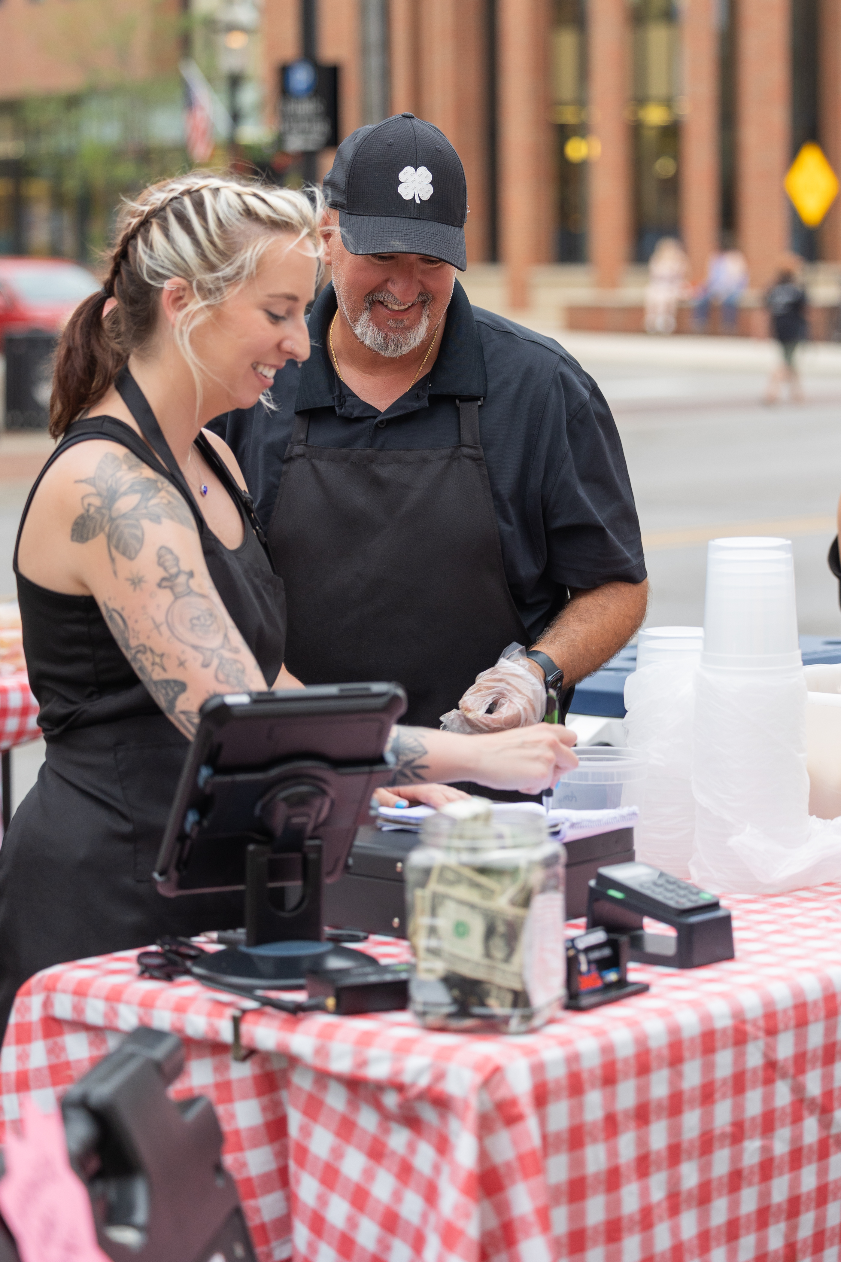 McDave smiling while serving customers