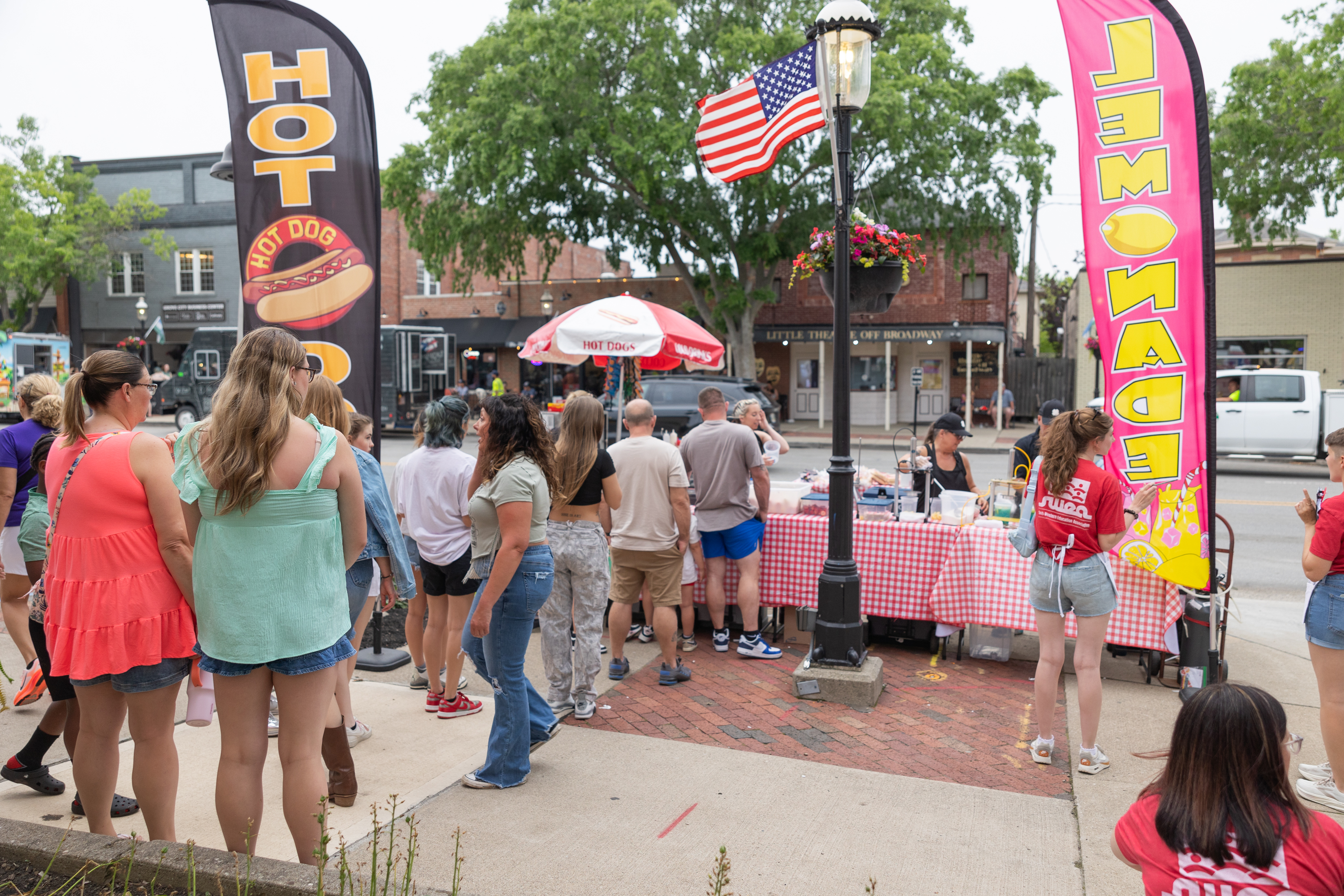 McDave’s hotdog cart setup on the street with customers