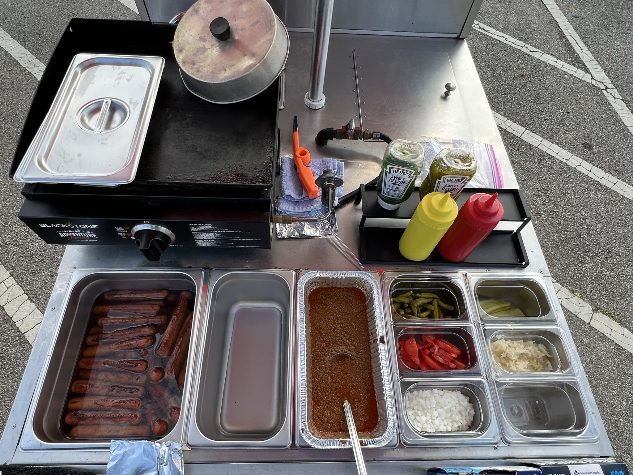 McDave’s street setup with umbrella, menu board, and cart
